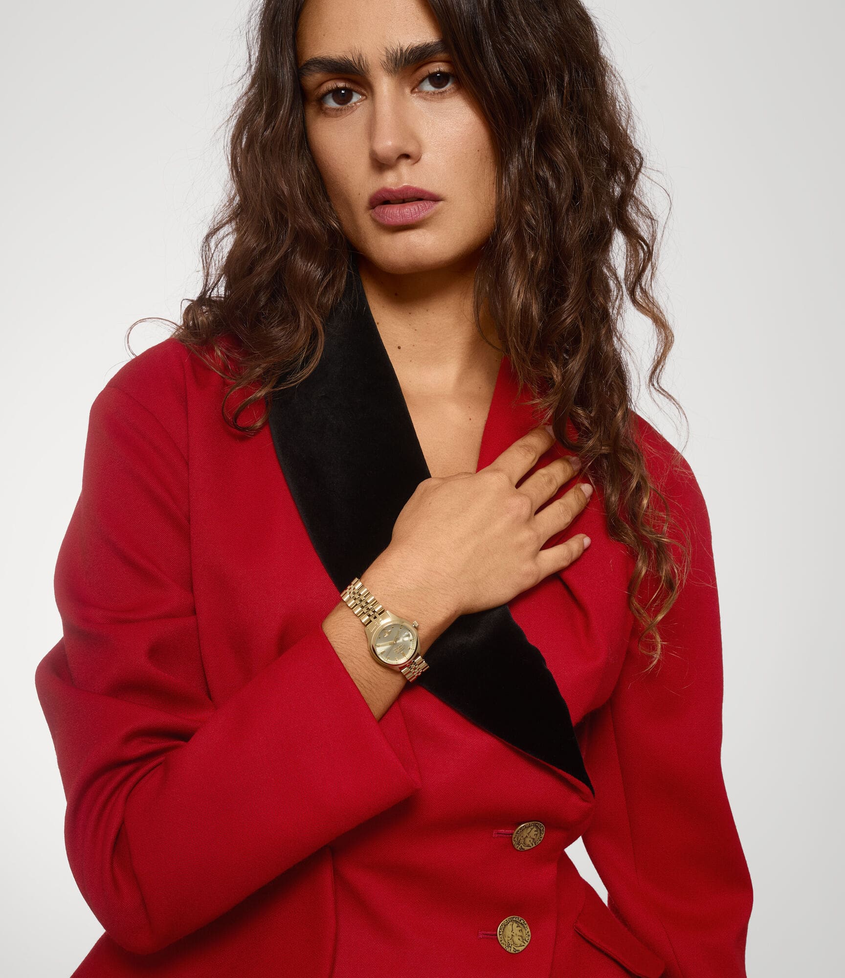 Woman wearing a red blazer with a Vivienne Westwood Little Camberwell Gold Watch VV311CPGD 8050164231835 on a white background