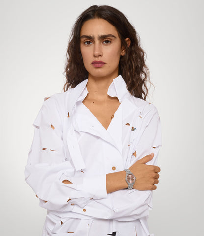 Woman wearing a white outfit with Vivienne Westwood Little Seymour Pink Dial Silver Watch VV328DPKSL 8050164231842 on a plain background