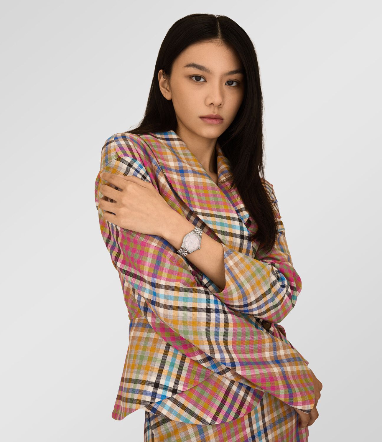 Woman wearing a colorful plaid jacket with Vivienne Westwood Little Wallace Silver Pink Watch VV327PKSL 8050164232023 on a white background