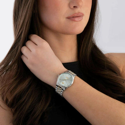 Woman wearing a Vivienne Westwood Seymour Blue Dial Silver Watch vv240lgrsg on her wrist with a neutral background