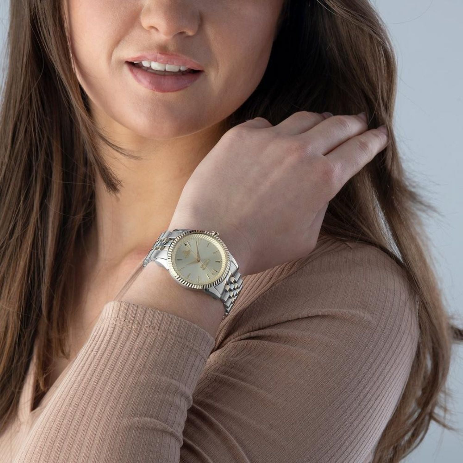 Woman wearing a Vivienne Westwood Seymour Champagne Dial Silver Watch VV240CPSG on her wrist against a neutral background