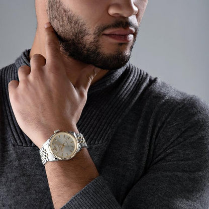 Man wearing a Vivienne Westwood Seymour Homme Champagne Dial Silver Watch VV242CMSG with a gray background