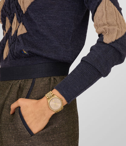 Person wearing a Vivienne Westwood Seymour Rose Dial Gold Watch vv240pkgd on a plain background